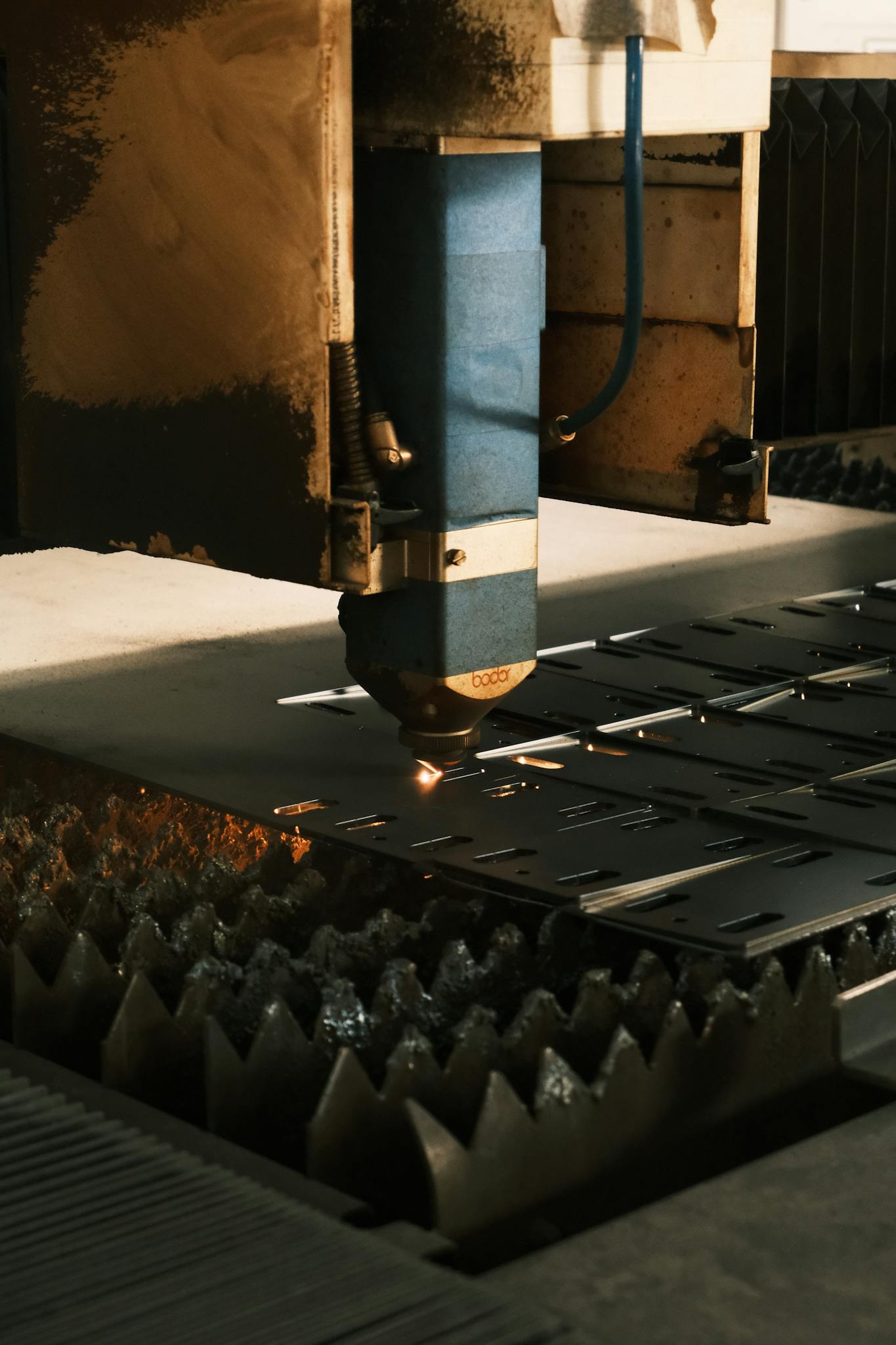 Close-up of a laser cutter in action, showcasing modern industrial technology.